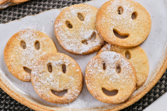 Presentación de galletas con forma de caras sonrientes.